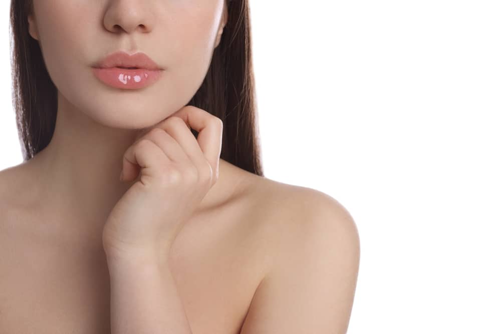 Woman with smooth skin and full lips after facial fillers
